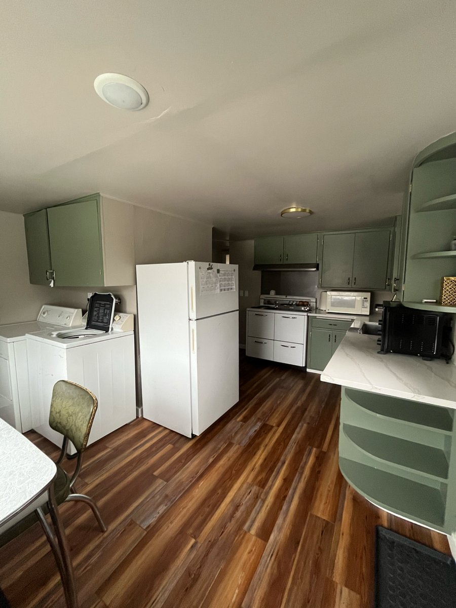 Kitchen with washer and dryer off to the side