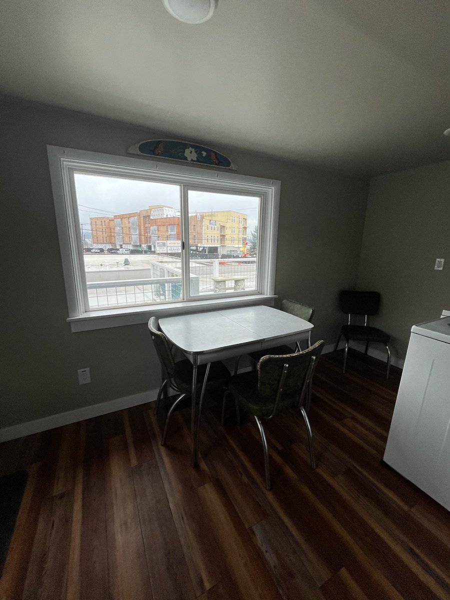 Kitchen table next to washer and dryer