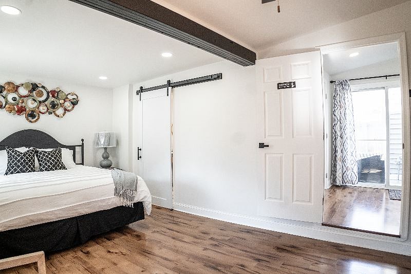 King size bedroom with farm door access to ensuite