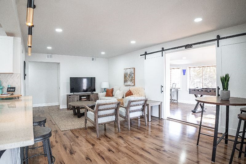 Open concept living area with access to kitchen and office