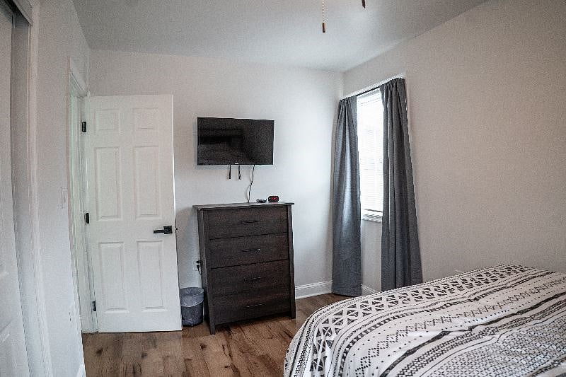 Full size bedroom with darkening curtains and Smart TV