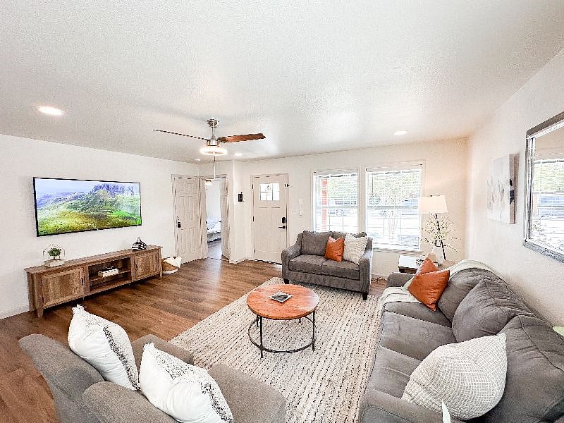 Entertain in this beautiful open concept space with TV, large windows, and kitchen island