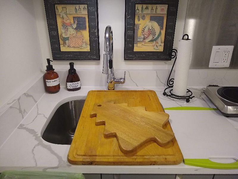 There are two cutting boards, which are also stored at the bottom of the under-counter cabinet.