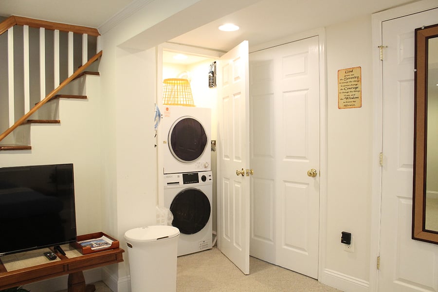The laundry closet is conveniently located in the main room.