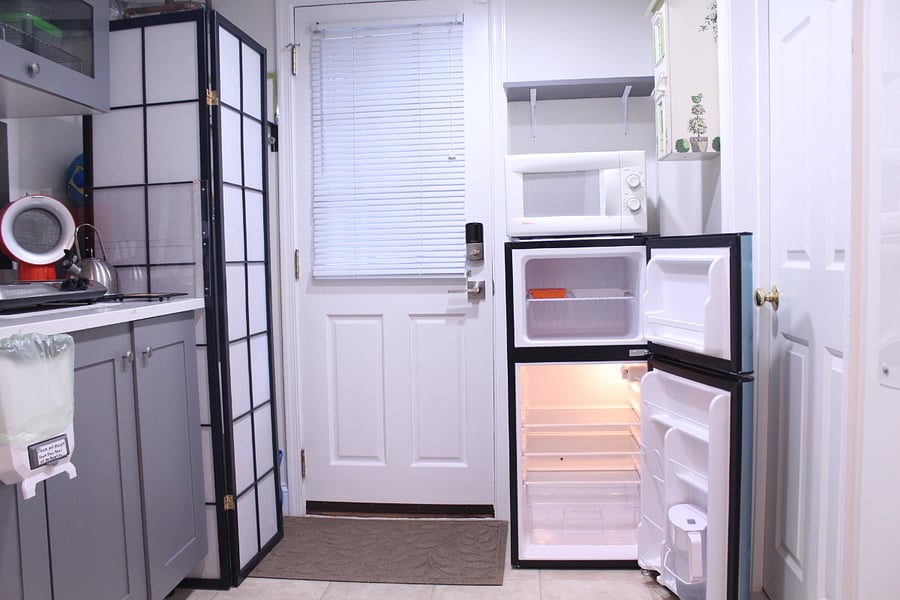 Another view of the kitchenette with a refrigerator/freezer and a microwave oven.