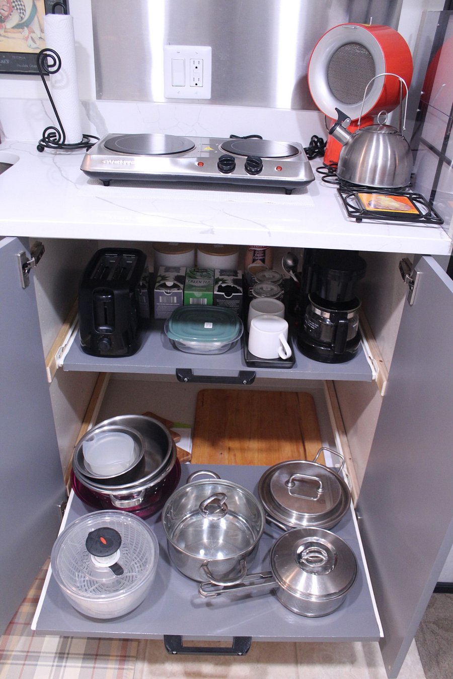 Close up view of the lower sliding shelf and the bottom of the cabinet.