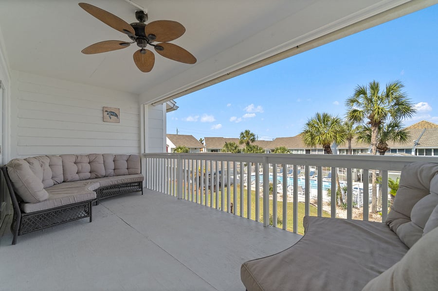 Balcony with sofas overlooking the community pool