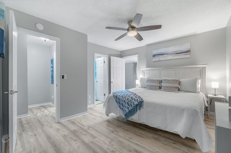 Upper master bedroom with king bed and ensuite bathroom.