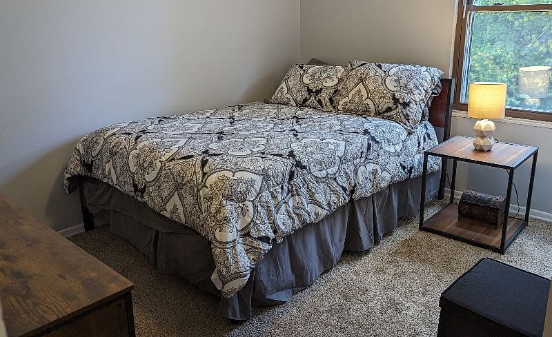 2nd Bedroom with Brand New Furniture and a storage ottoman with extra blankets for your comfort. This room has a nice wooded view.
