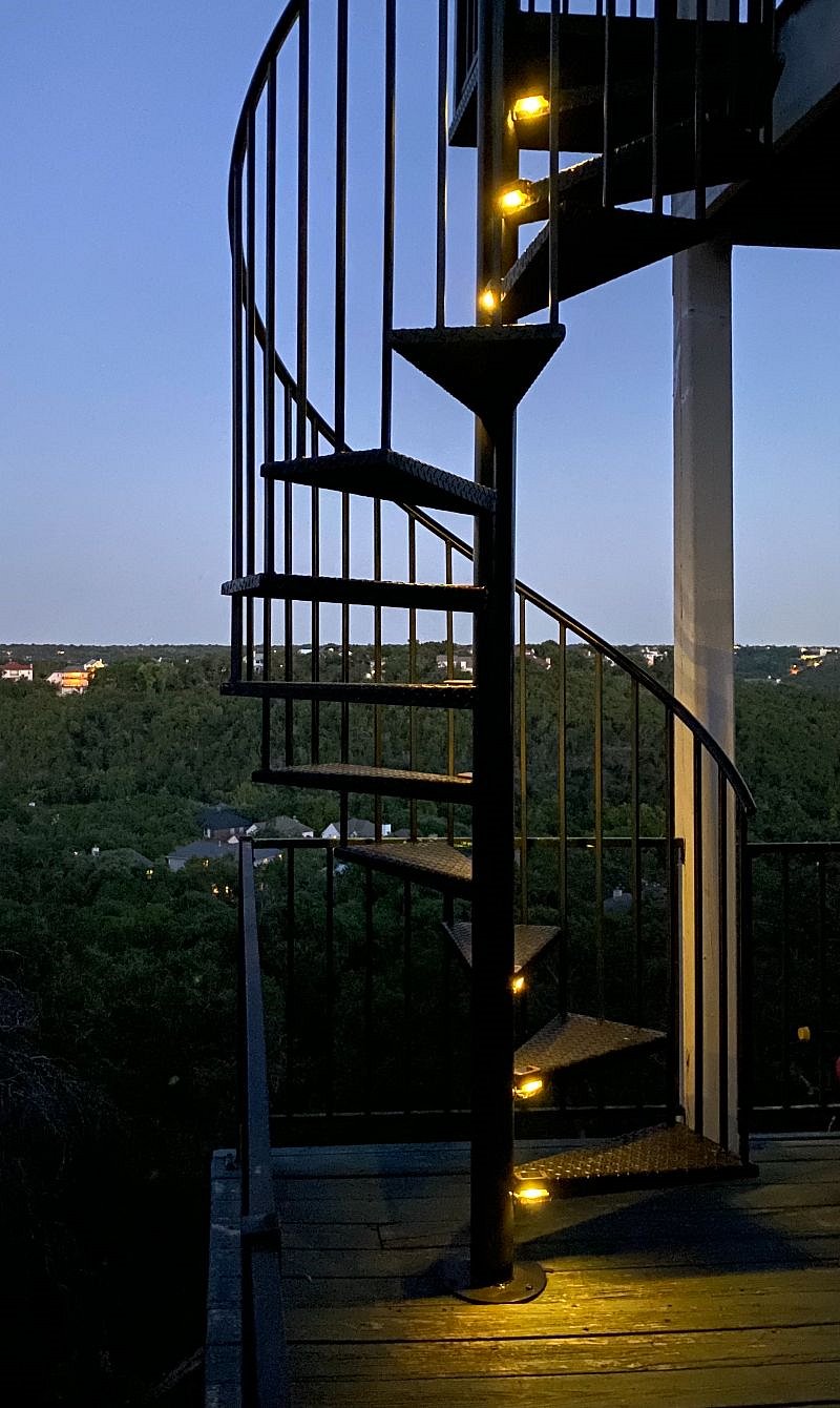 Spiral stairs lead directly to private balcony