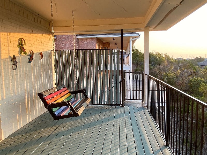 Porch swing and stairway up to private deck