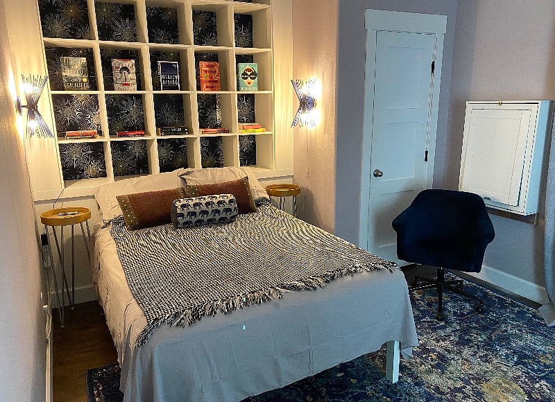 Bedroom has fold down desk, walk in closet, mini fridge, microwave with private balcony.