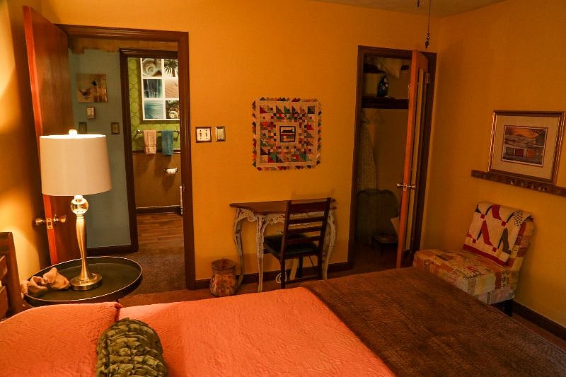 Spacious closet with extra bedding, ironing board and iron. 