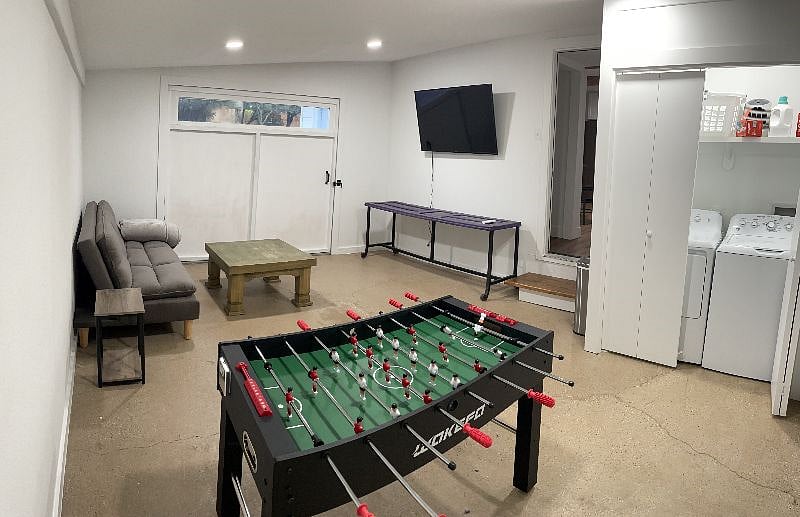Game room with TV, foosball table, and futon. Washer & dryer located here. This area is cooled by a mini-split unit and can be heated by a portable heater.