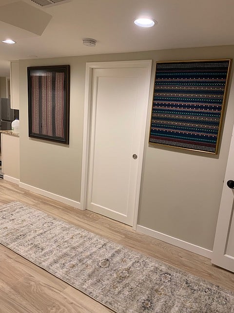 Hallway, tapestries flanking door to bathroom