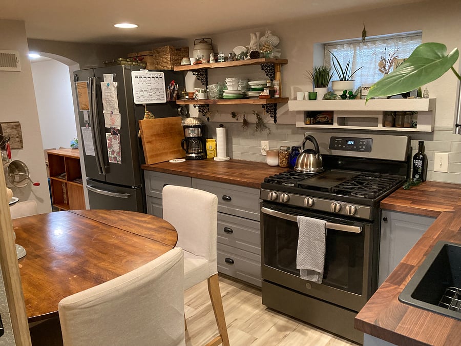 Kitchen with full size fridge. Fully stocked with cooking utensils, pots & pans, condiments, coffee maker and cleaning supplies.