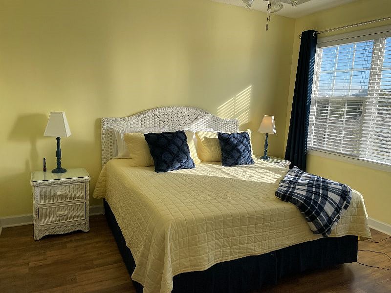 Master bedroom with king bed, blinds and room darkening curtains.