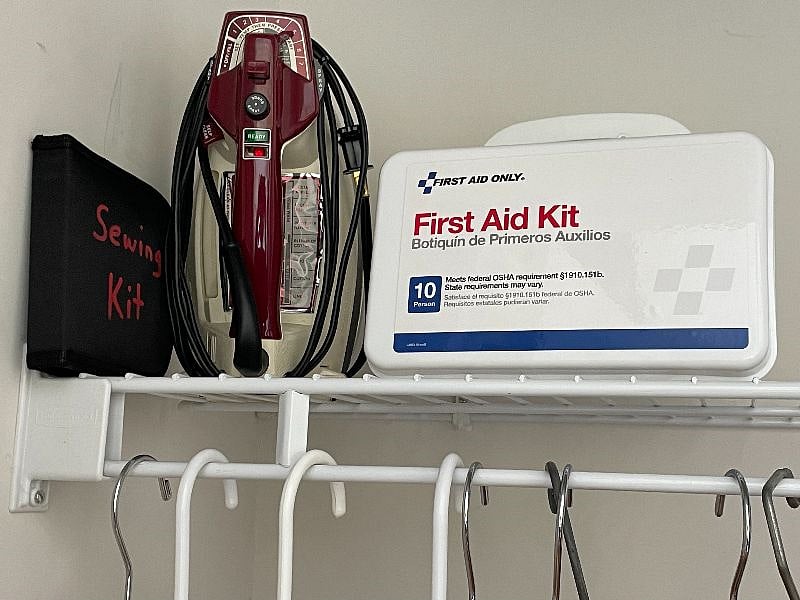 First aid kit, iron, sewing kit in master bedroom closer