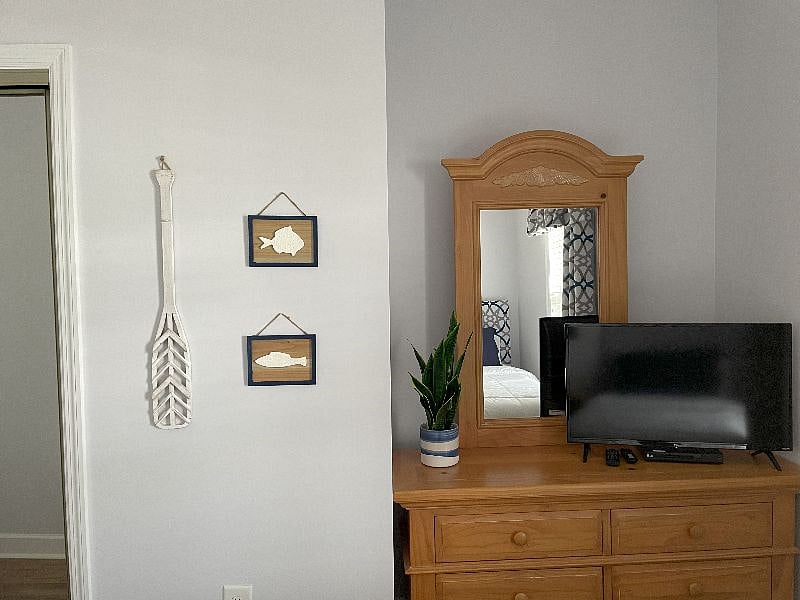 Twin bedroom dresser & Roku TV.  Double door closet with full length mirrors on each door. 