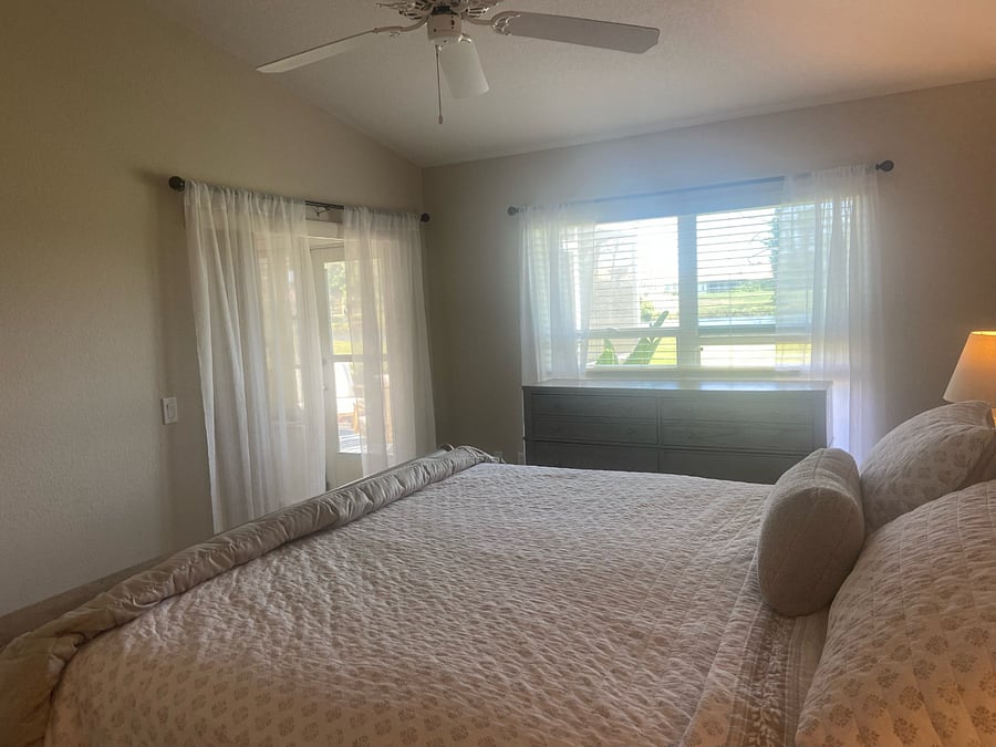 Another bedroom view showing the full size dresser and outside view of the golf course/water.