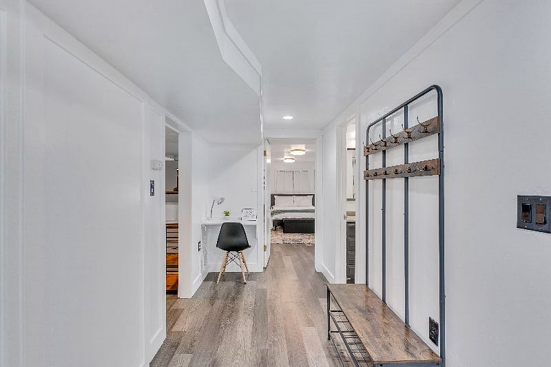 Hallway with shoe/coat rack and small workspace