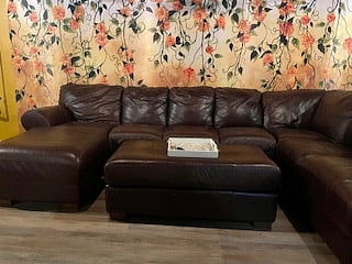 Sectional couch in basement with Smart TV