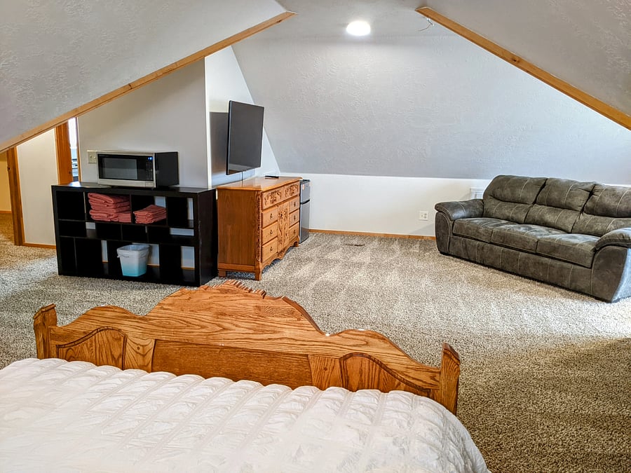 Huge loft bedroom above the 4 car garage. Beautiful queen bed frame with medium tempur-pedic mattress. This is a spaciously large room equipped with your very own tv, dressers, a closet dresser, mini refrigerator, microwave, blackout curtains, queen pullout sofa couch and a private full bathroom.