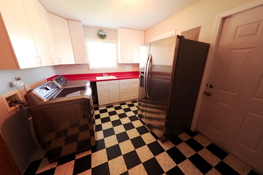 Washer/Dryer room with additional refrigerator.