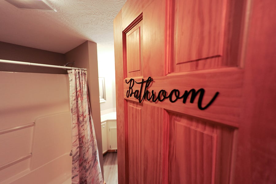 Shared full bathroom along hallway. Half bathroom is located in the garage as well.