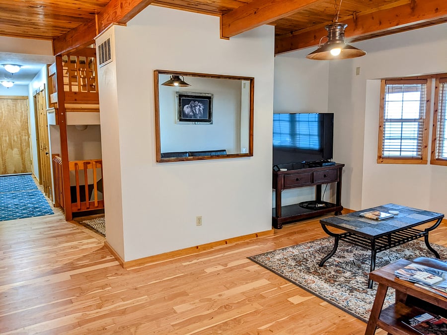 Shared living room area with hallway. Queen bedroom for this listing is located on the left.
