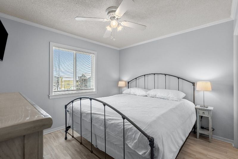 King bed in primary bedroom, wall mounted TV
