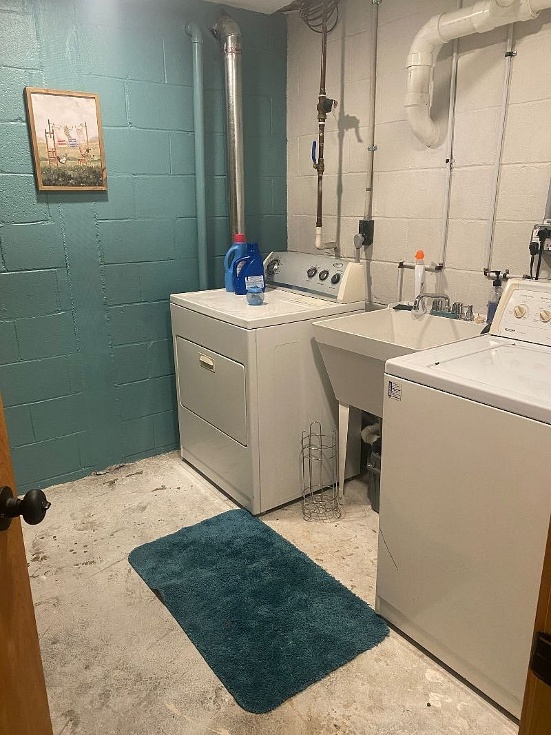 Laundry room with full washer and dryer.