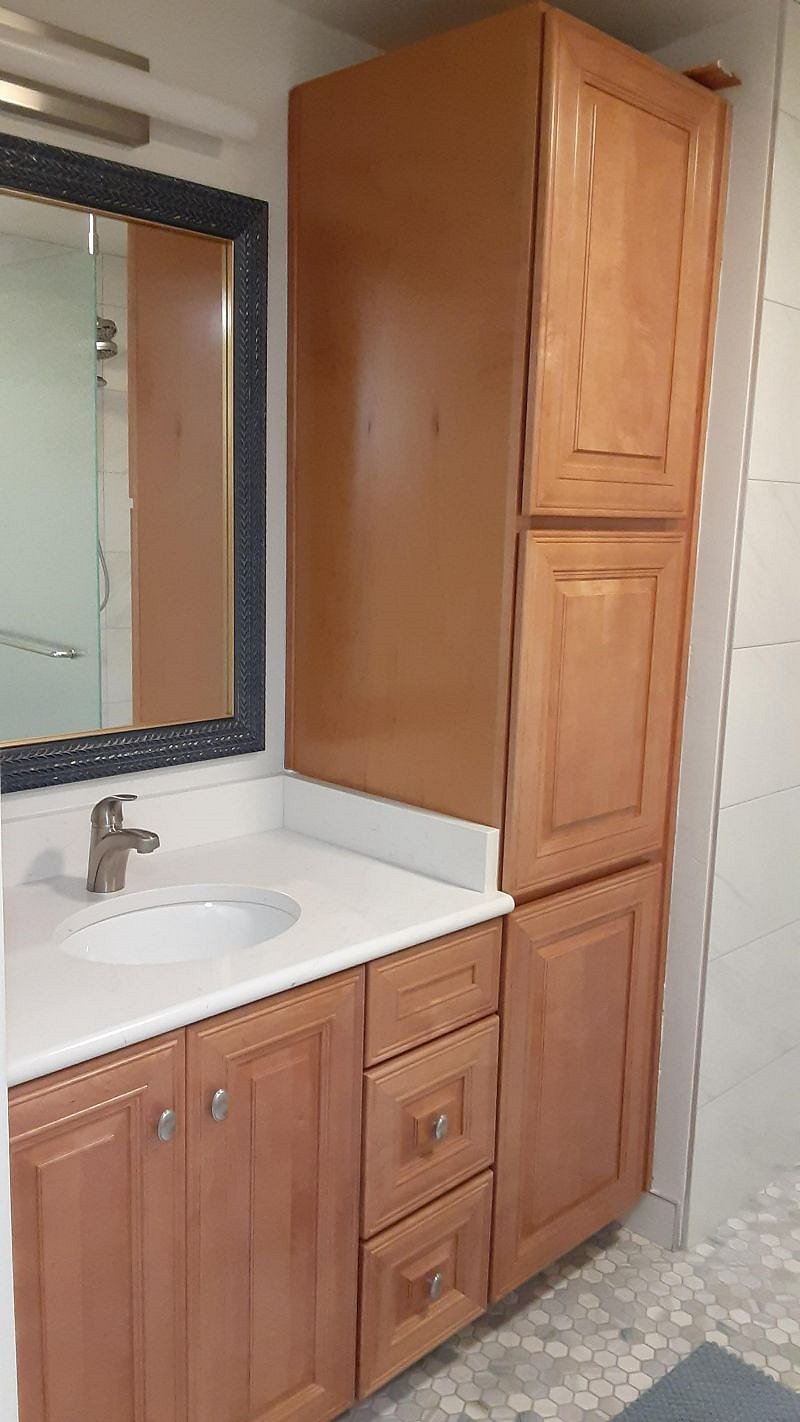 Quartz counter with plenty of storage, towels and starter toiletries.