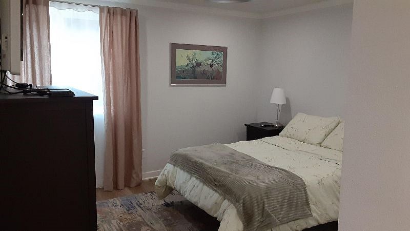Bedroom with plenty of linens and comfortable bedding.