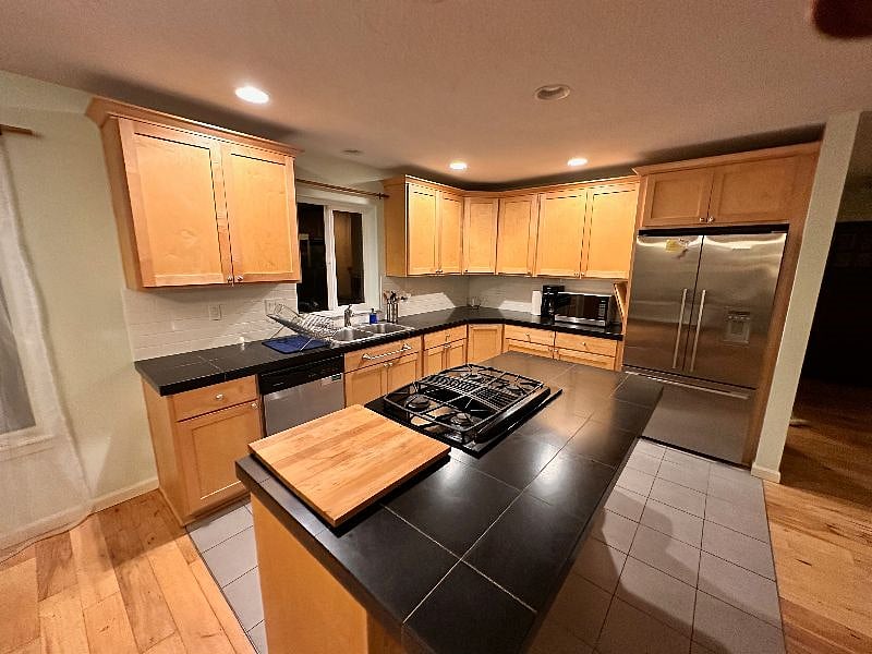 Spacious kitchen with plenty of counter space, fully stocked with pots / pans and cooking supplies - perfect for those who enjoy cooking.