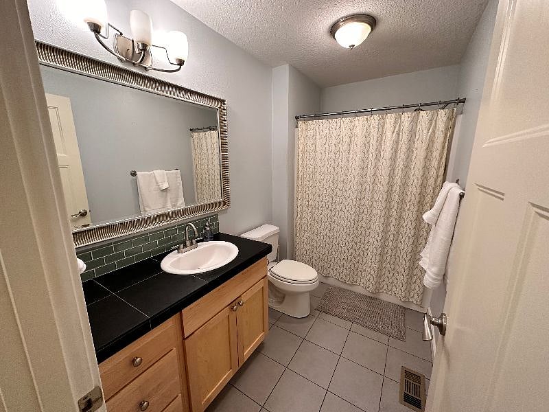 Main bathroom features tub / shower and individual drawers for storage.