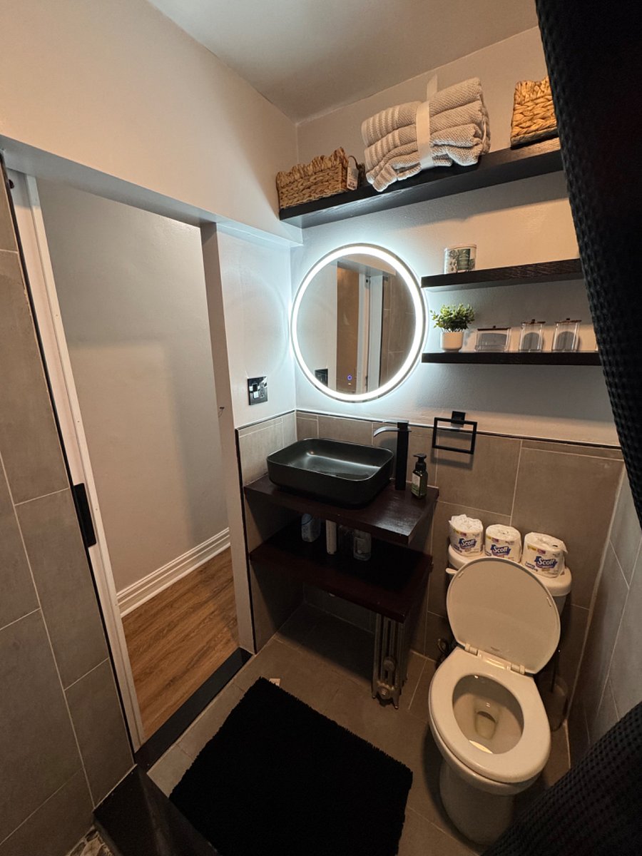 The bathroom features a touch sensitive mirror and the vent has bluetooth speakers for guests to listen to music while they shower.