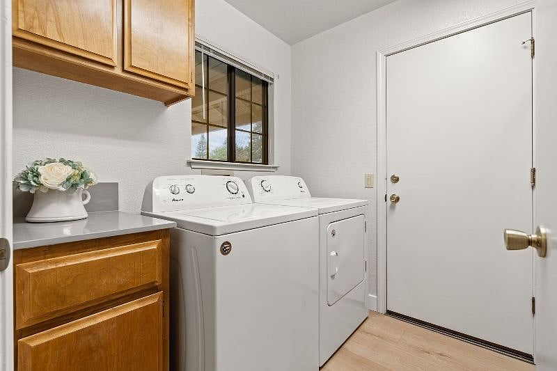 Dedicated laundry area off the hallway between the attached garage and the home.