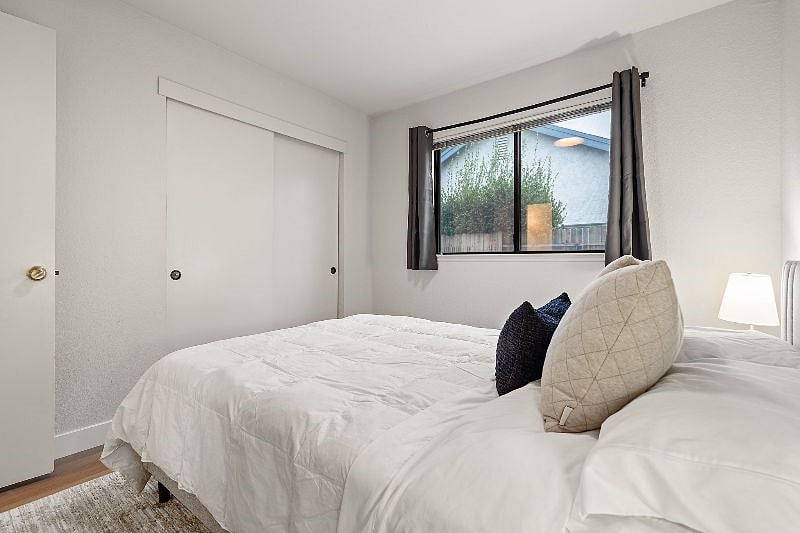 Third bedroom with full length mirror on side wall.