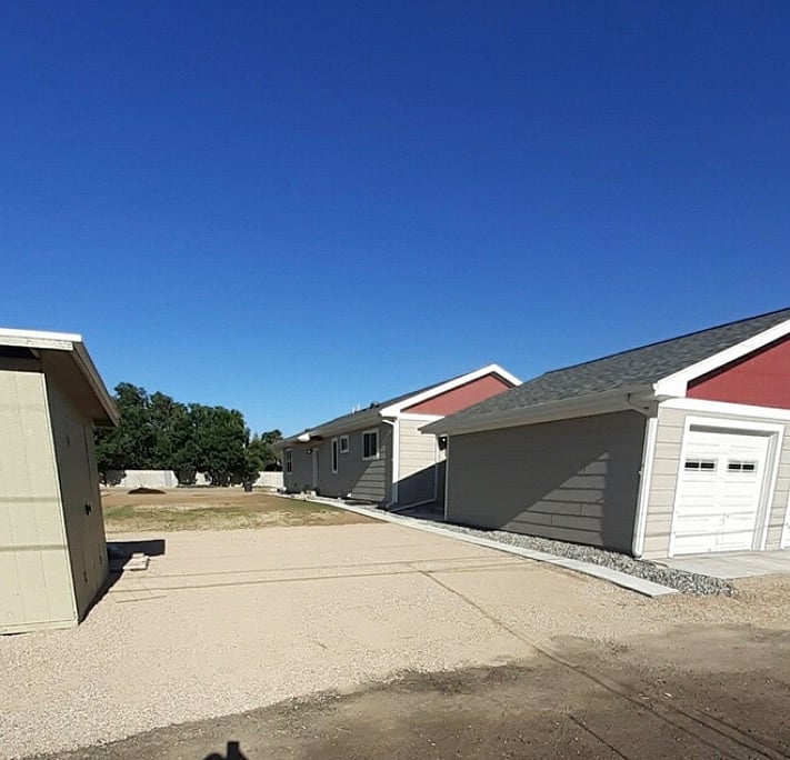 Dedicated parking rear of property, concrete sidewalk to entry door.