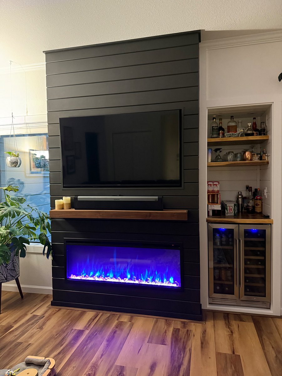 Newly remodeled living room with a mini-bar and fireplace/tv