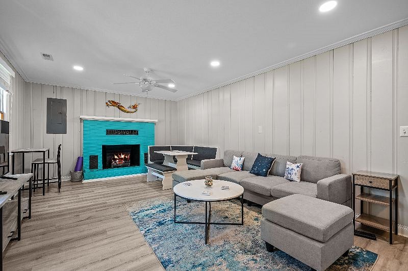 Living/dining room combo with desk nook to left of fireplace.