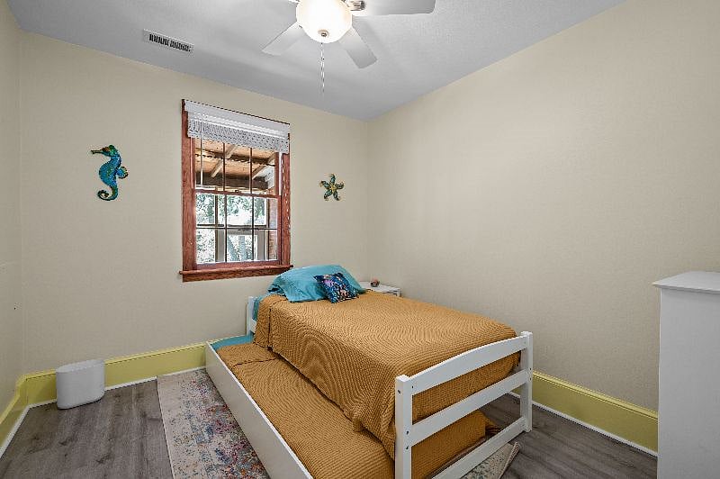 Second bedroom has twin bed and twin trundle bed. Nightstand to the right side of the bed.