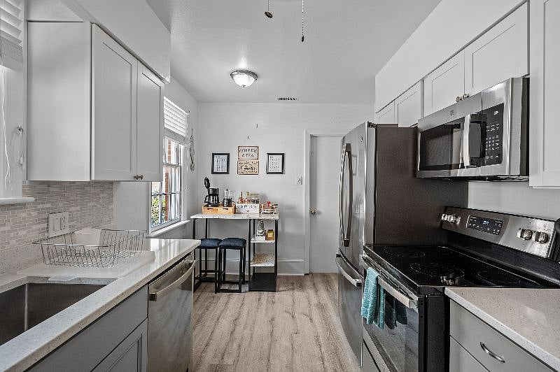 Galley kitchen with coffee/tea/hot cocoa bar. Fully stocked. Fridge, oven, cooktop, and microwave on right side of this photo.