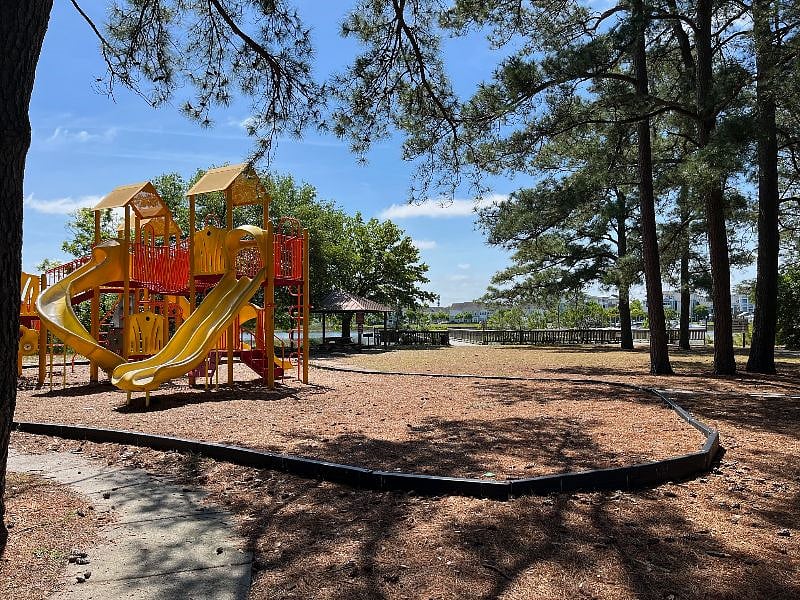 Fishing pier next to children's playground.