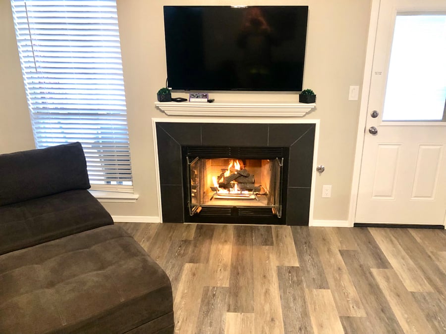 Living room with gas log fireplace and 60 smart tv