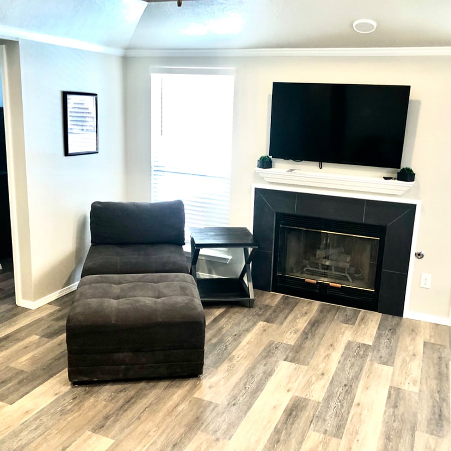 Living room with gas log fireplace and smart tv