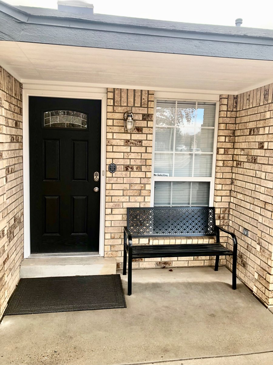 Front door with smart lock and sitting bench