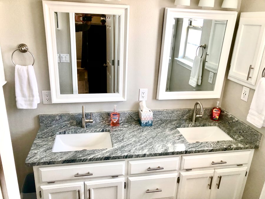 Primary bedroom private bathroom with double vanities. Tissue, towels and soap provided