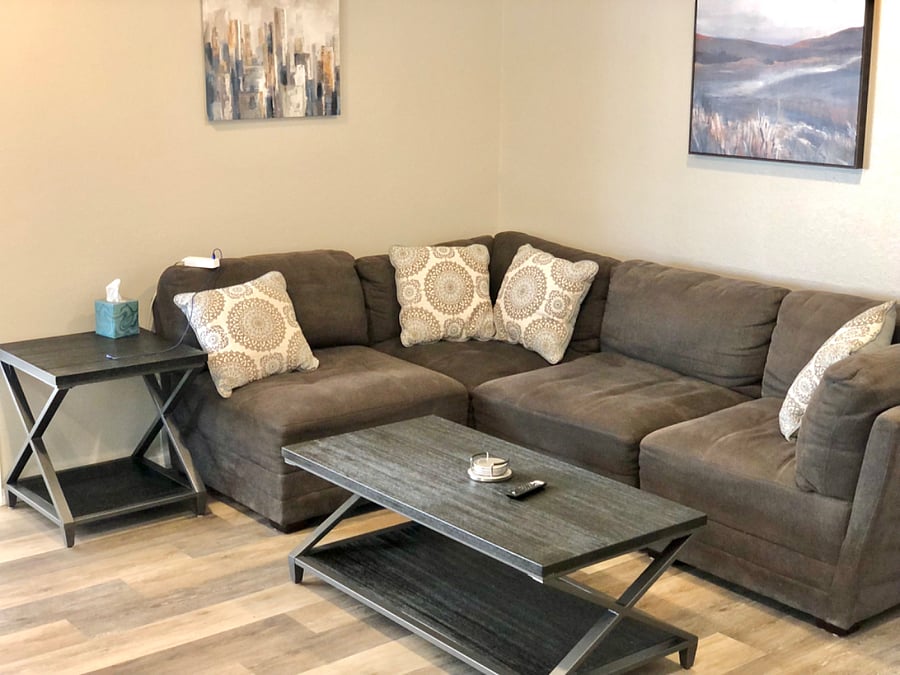 Living room with sectional sofa, coffee table, end table and smart TV